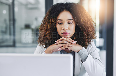 Buy stock photo Shot of a young businesswoman looking thoughtful while working on a laptop in an office