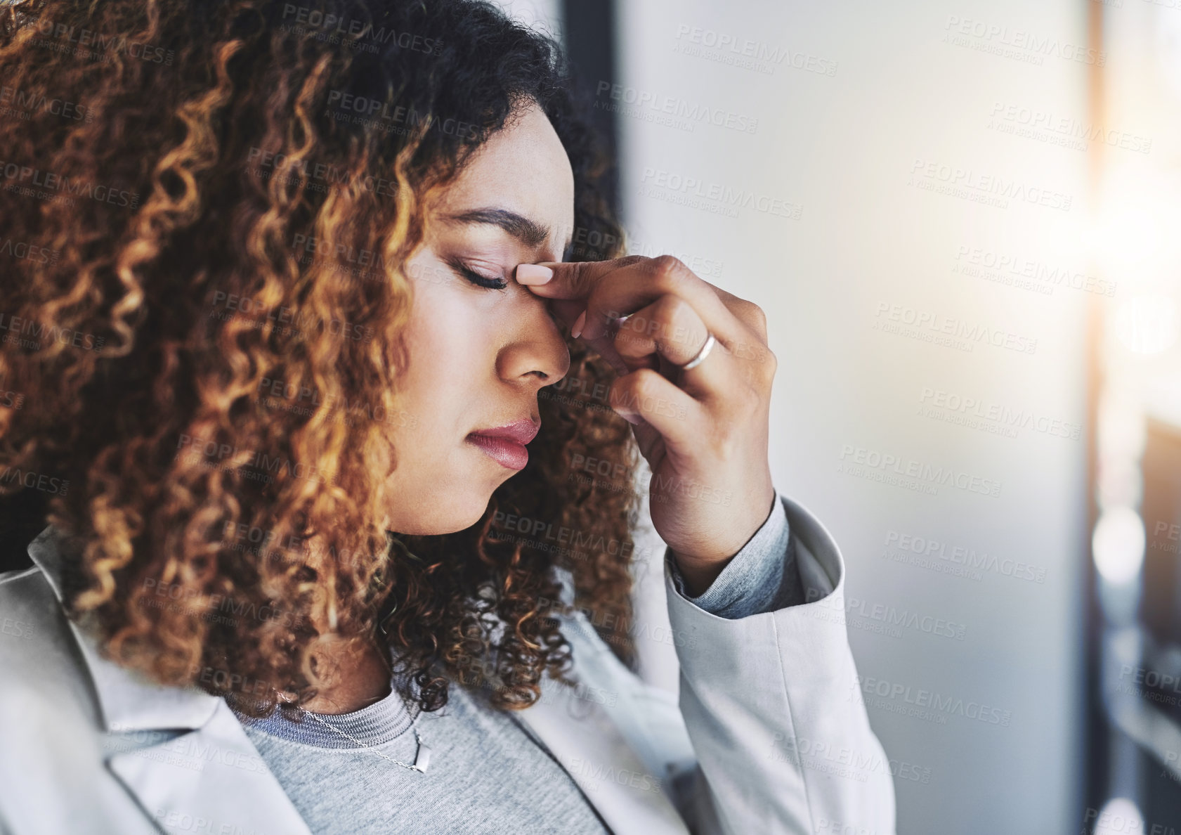 Buy stock photo Shot of a young businesswoman looking stressed out in an office