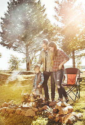 Buy stock photo Shot of a young family camping in the forest