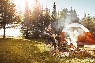 Buy stock photo Shot of a young Dad and his son camping in the forest