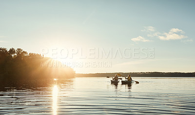 Buy stock photo Shot of a young couple kayaking on a lake outdoors