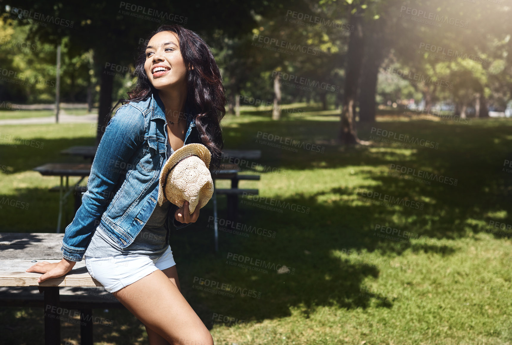 Buy stock photo Shot of an attractive young woman spending a day in the park