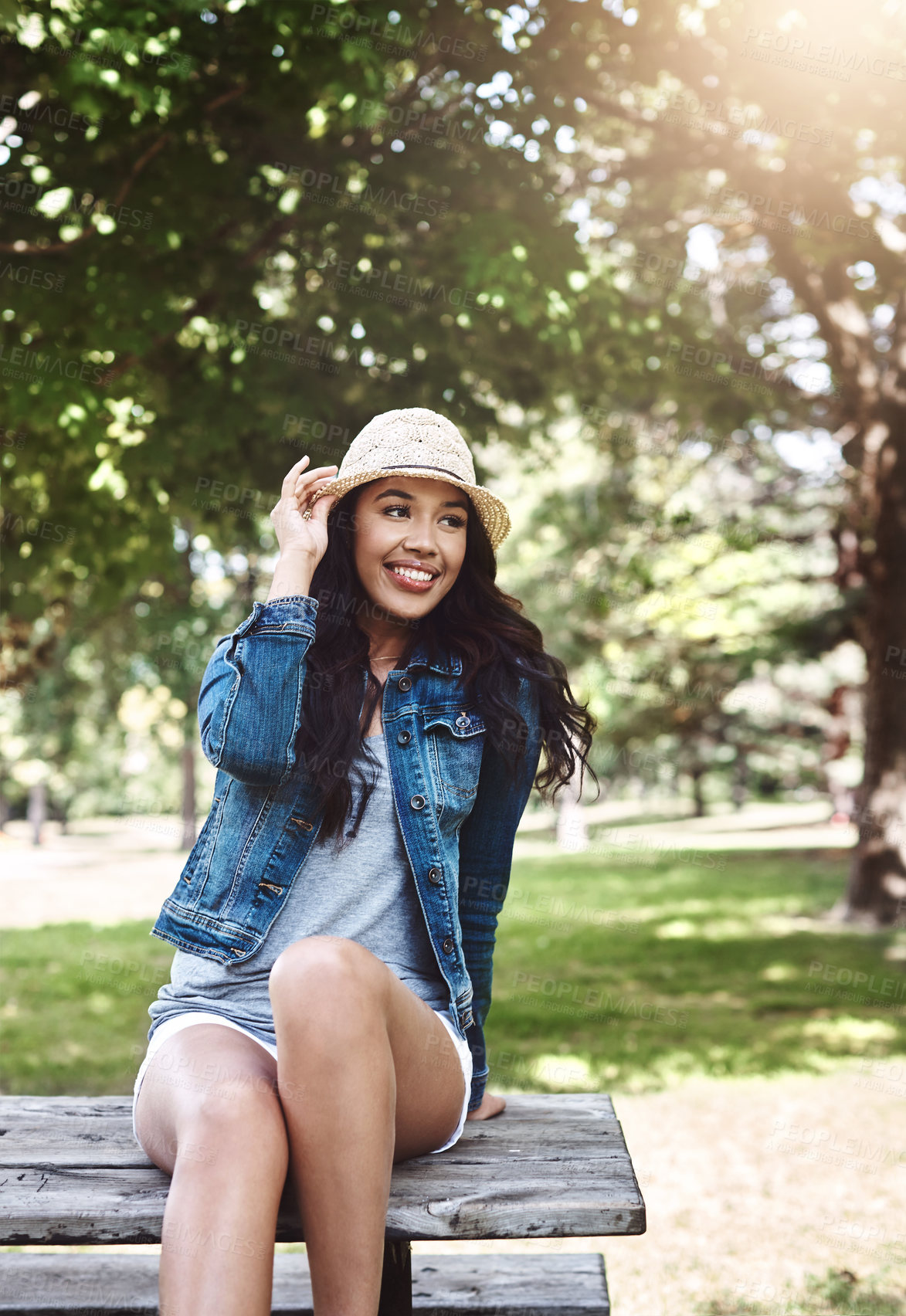 Buy stock photo Shot of an attractive young woman spending a day in the park