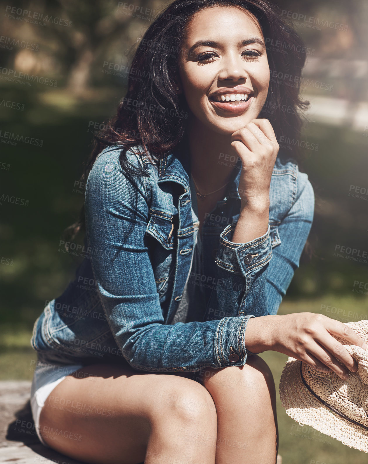 Buy stock photo Portrait, smile and woman in nature for fashion, summer style and confidence with aesthetic at park. Trendy, outdoor and happy girl with casual clothes, jeans jacket and relax with hat in Portugal