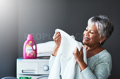 Buy stock photo Smell, woman and clean clothes at house for fresh scent, aroma and fabric fragrance for spring cleaning. Mature, female person and laundry service, cleaner and detergent soap for maintenance at home