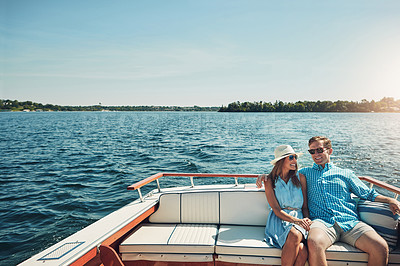 Buy stock photo Shot of a young couple spending time together on a yacht