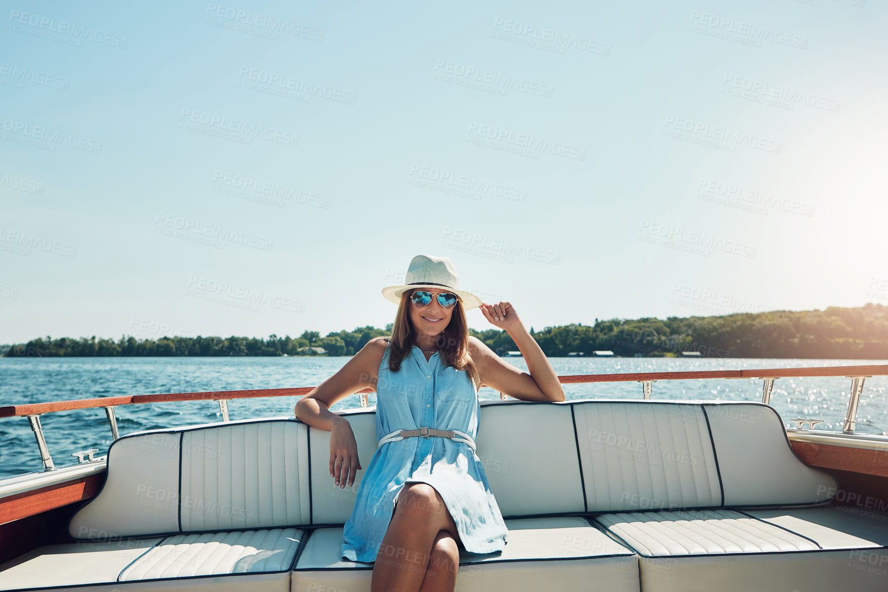 Buy stock photo Portrait of an attractive young woman spending the day on her private yacht