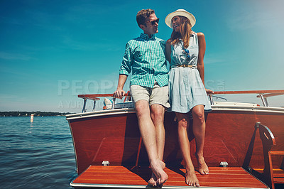 Buy stock photo Shot of a young couple spending time together on a yacht