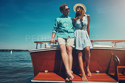 Buy stock photo Shot of a young couple spending time together on a yacht