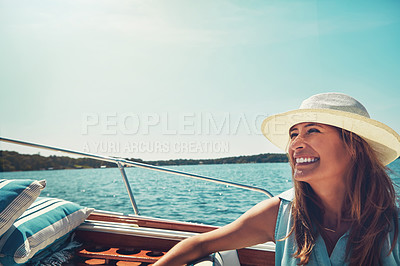 Buy stock photo Cropped shot of an attractive young woman sitting at the back of a yacht on the open seas