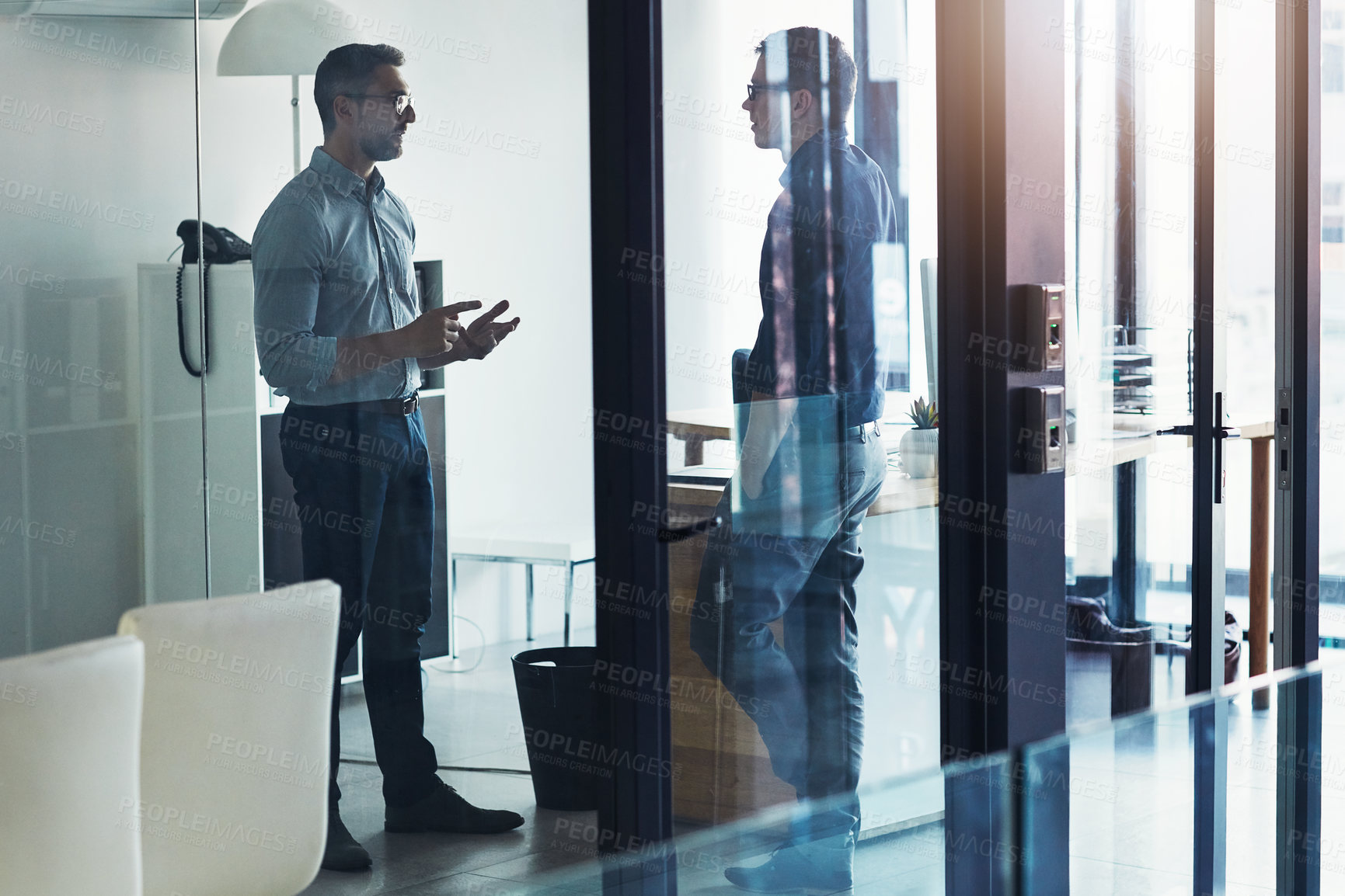 Buy stock photo Shot of two businessmen having a discussion in an office