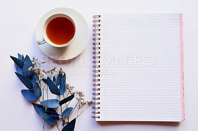 Buy stock photo Top view, diary and tea for writing on desk, flowers and sustainable paper for gratitude journal. Notepad, blank memo and beverage for planning or inspiration, idea drink and book for creativity