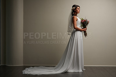 Buy stock photo Studio shot of a young beautiful bride posing against a grey background