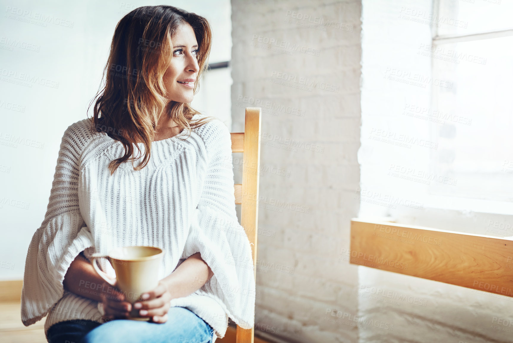 Buy stock photo Shot of an attractive young woman relaxing at home