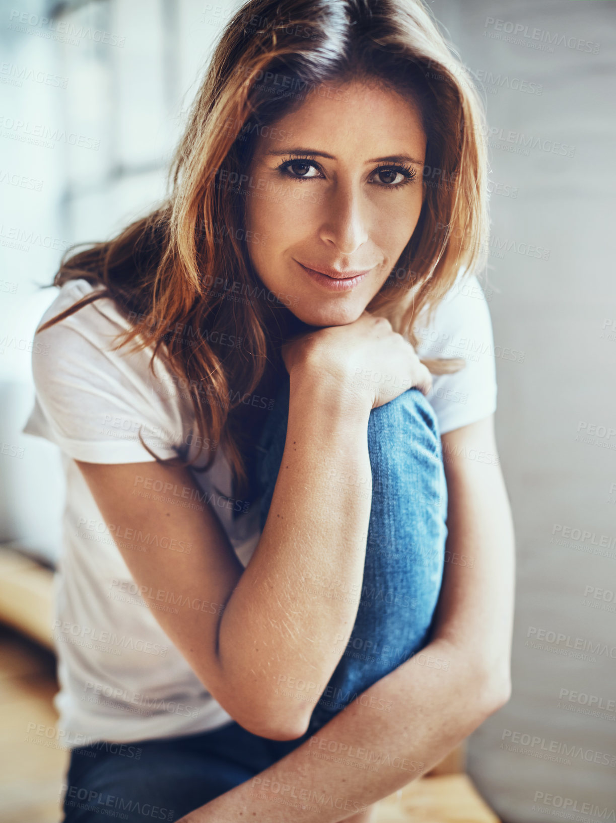 Buy stock photo Portrait of an attractive young woman relaxing at home