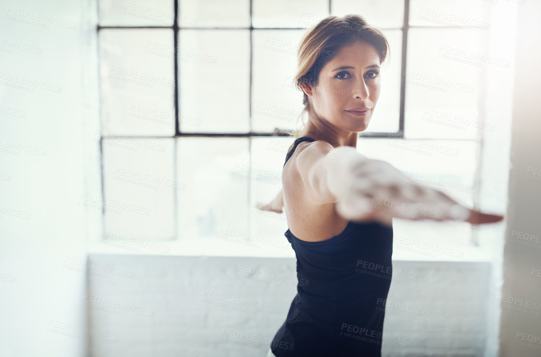 Buy stock photo Shot of an attractive young woman practising yoga at home