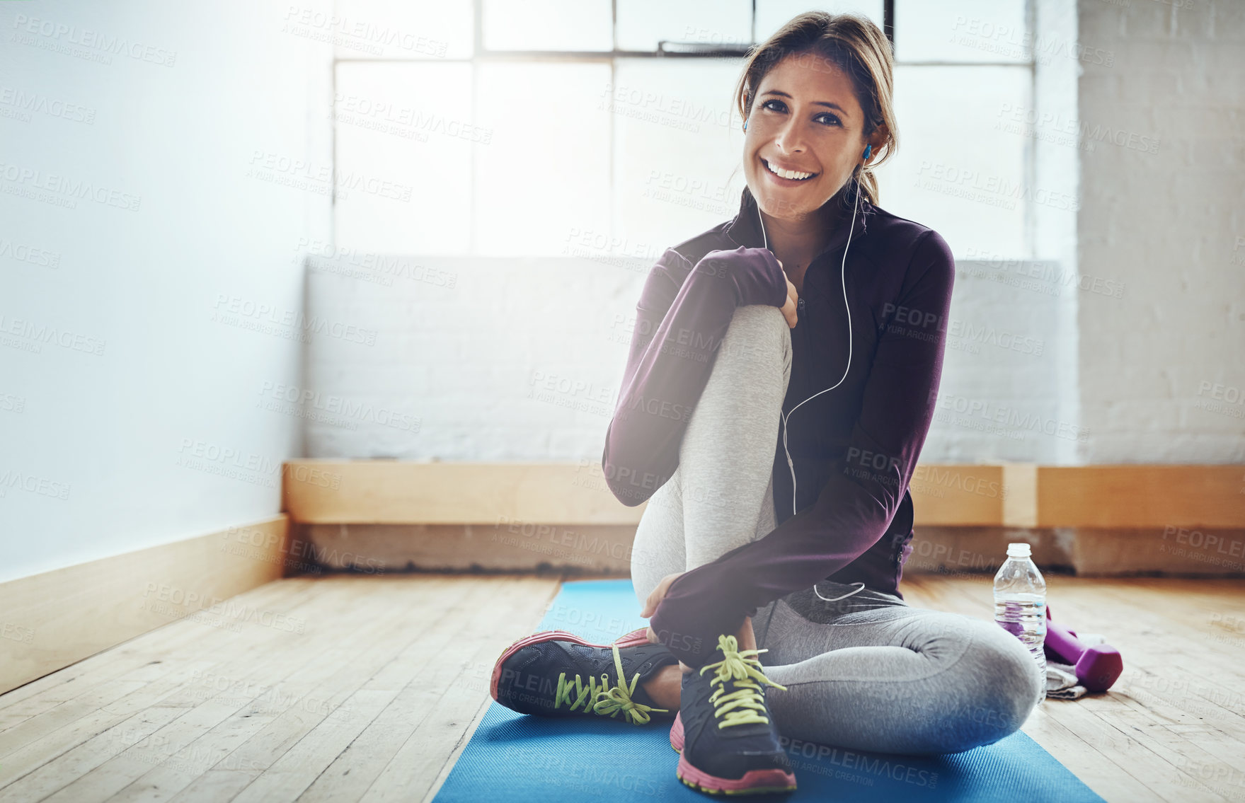 Buy stock photo Happy woman, fitness and portrait in gym with earphones, relax and ready for workout with water. Female person, smile and music for exercise with hydration, positive mental health and audio book