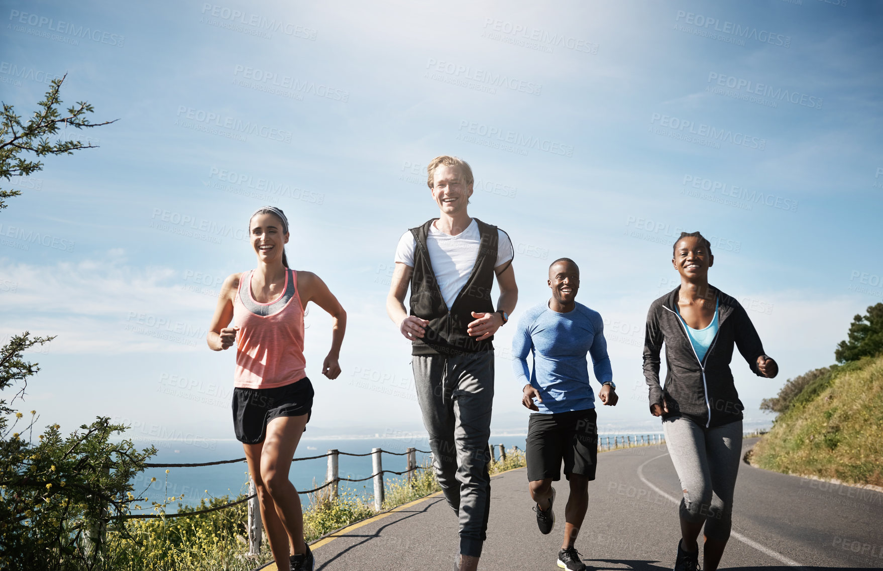 Buy stock photo People, couple of friends and jogging in road for fitness with smile to exercise and workout. Diversity, outdoor and happy with running in sportswear for health, wellbeing and self care with routine