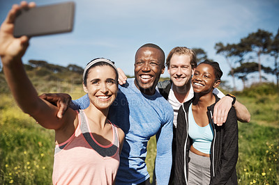 Buy stock photo Shot of a group of friends taking a selfie outdoors after their workout