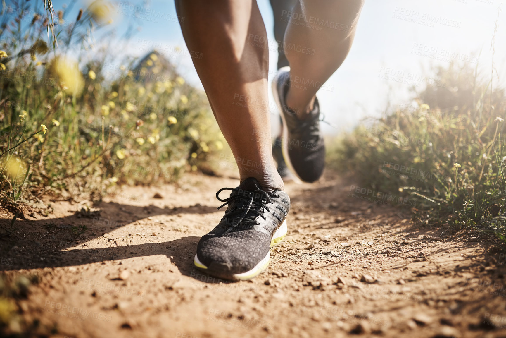 Buy stock photo Low angle shot of an unrecognizable man out running