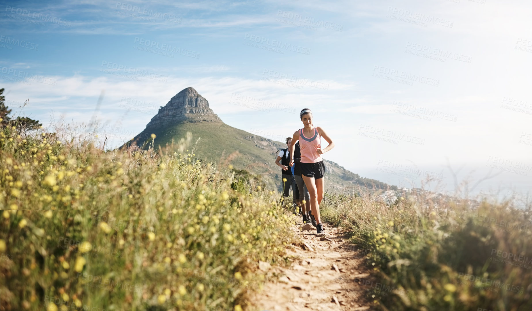 Buy stock photo Fitness, woman and group running on mountain for cardio workout, competition training or challenge. Teamwork, runner or morning jog in nature for marathon exercise, endurance or healthy body on path