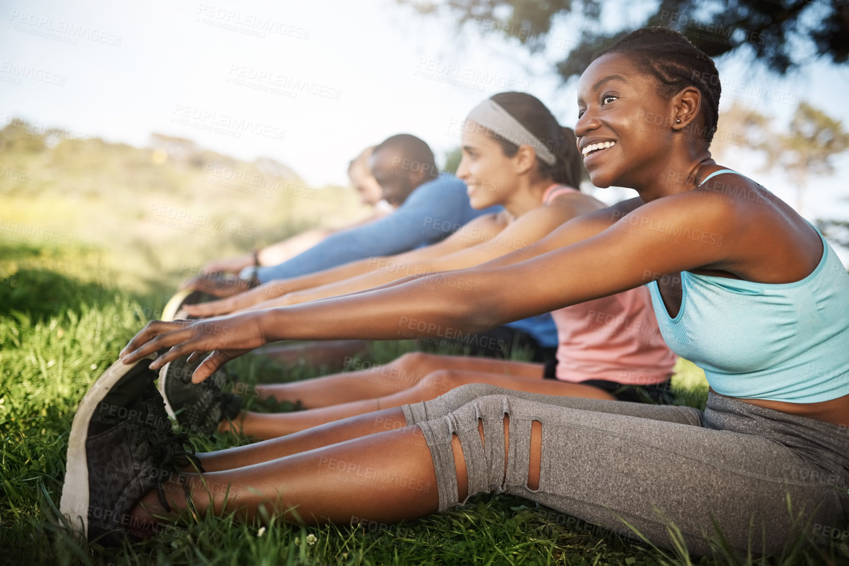 Buy stock photo Shot of a fitness group stretching before their run