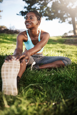 Buy stock photo Shot of a young woman stretching before her run