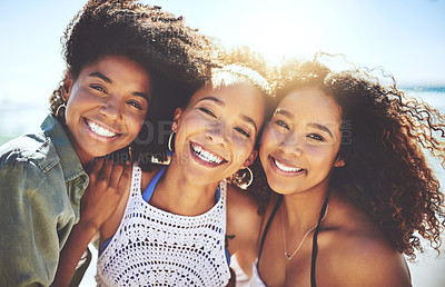 Buy stock photo Cropped shot of three friends enjoying themselves at the beach on a sunny day