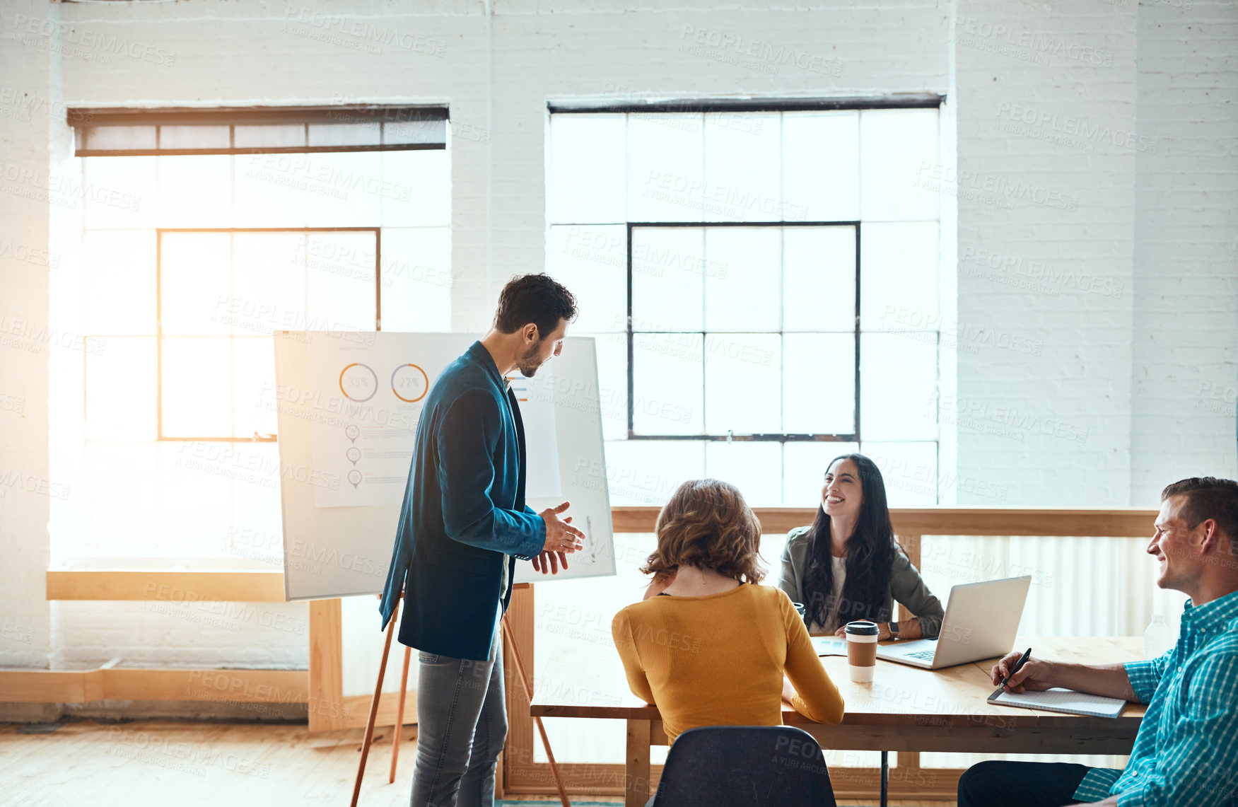 Buy stock photo Shot of a group of young businesspeople having a meeting in a modern office