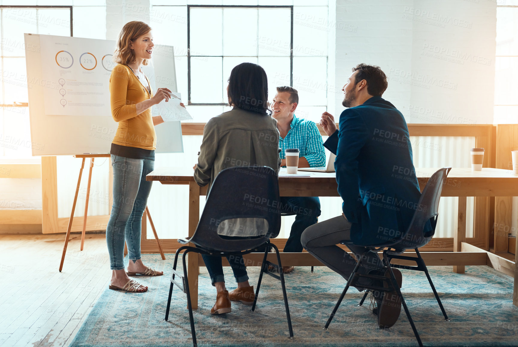 Buy stock photo Shot of a group of young businesspeople having a meeting in a modern office