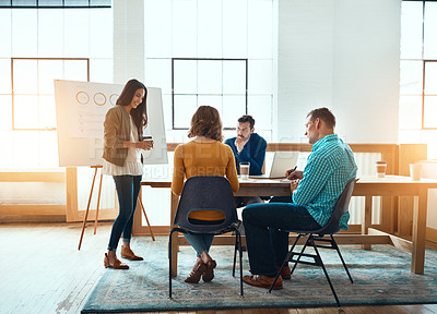 Buy stock photo Shot of a group of young businesspeople having a meeting in a modern office