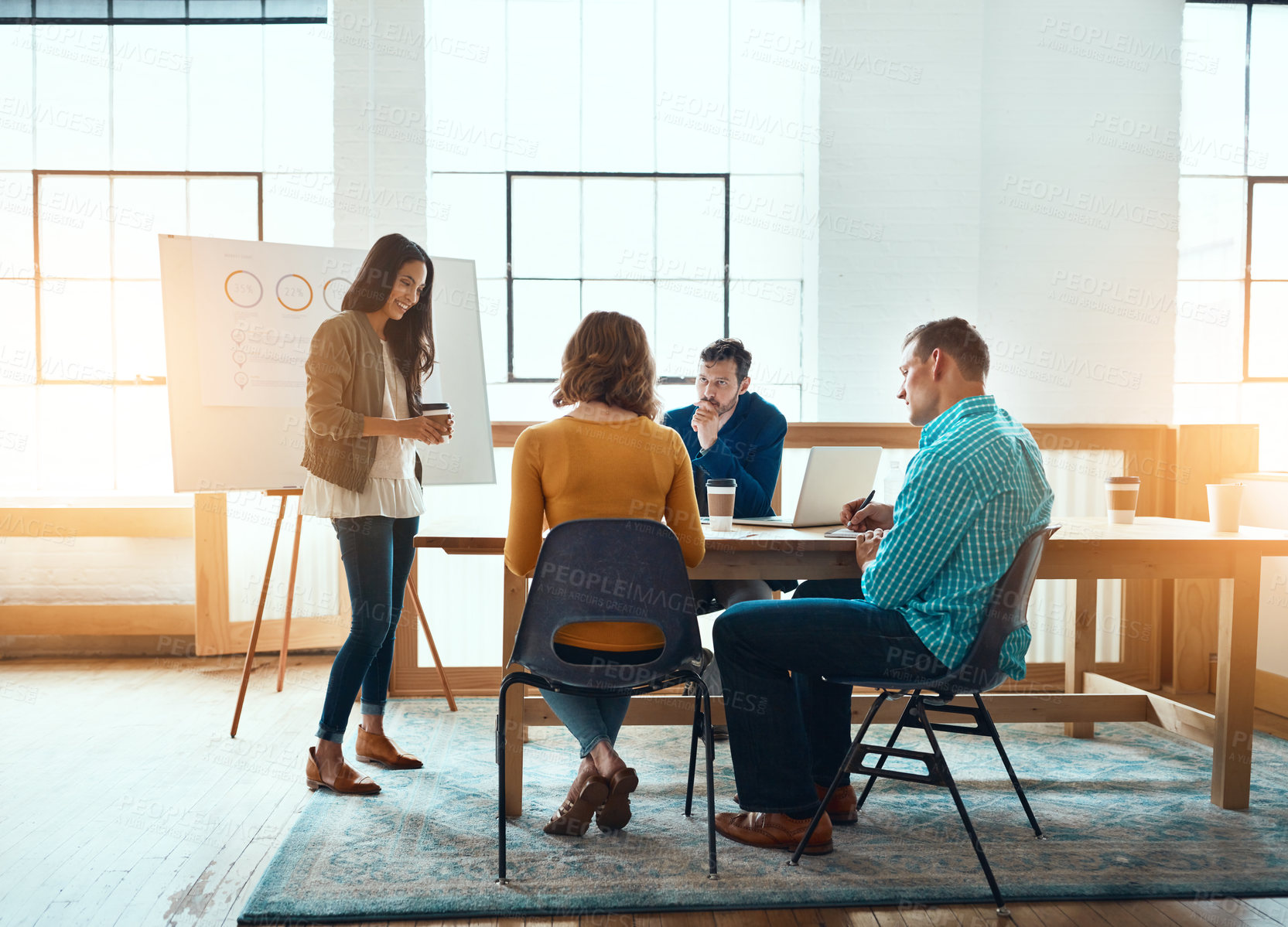 Buy stock photo Shot of a group of young businesspeople having a meeting in a modern office