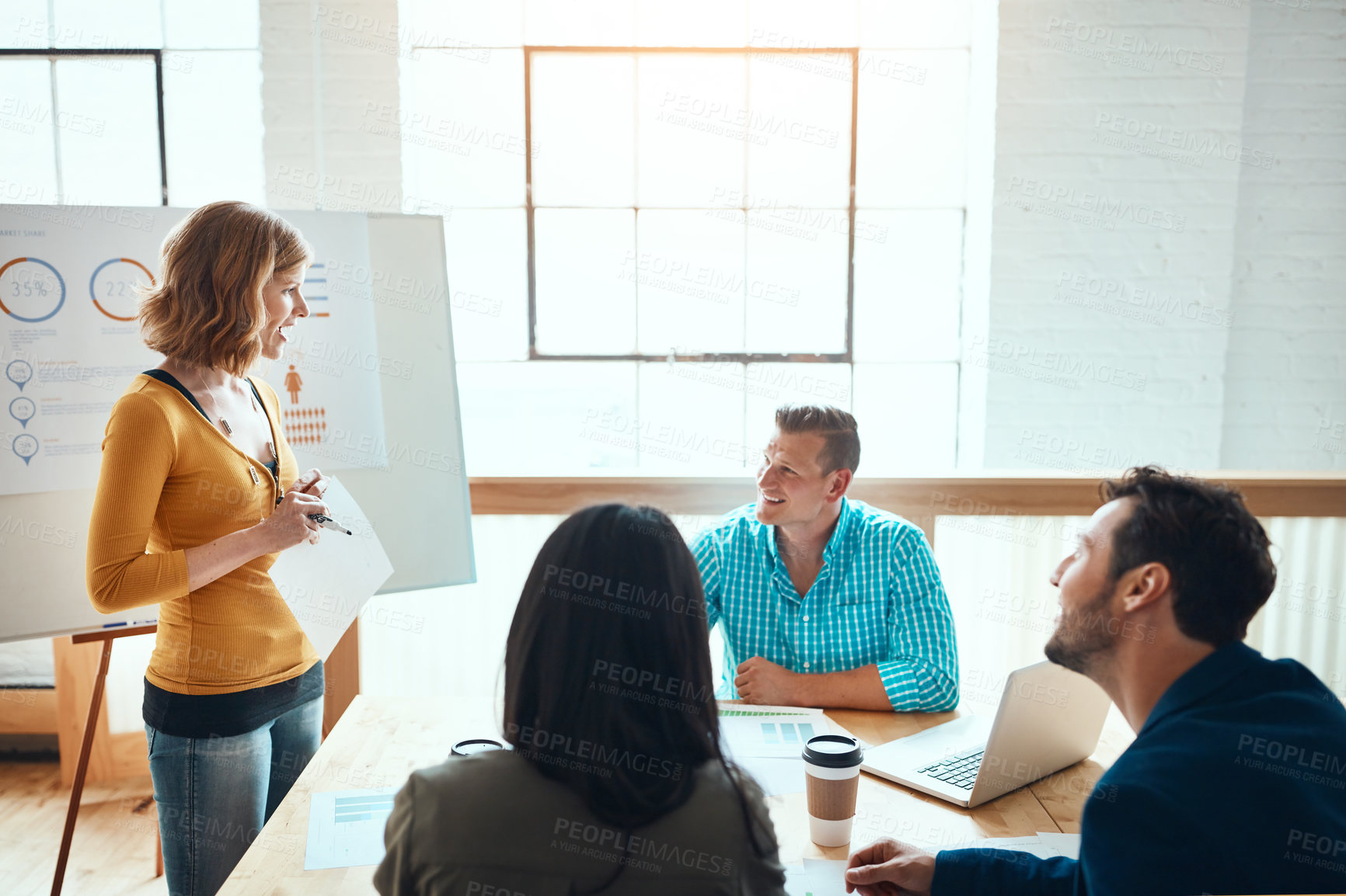 Buy stock photo Shot of a group of young businesspeople having a meeting in a modern office