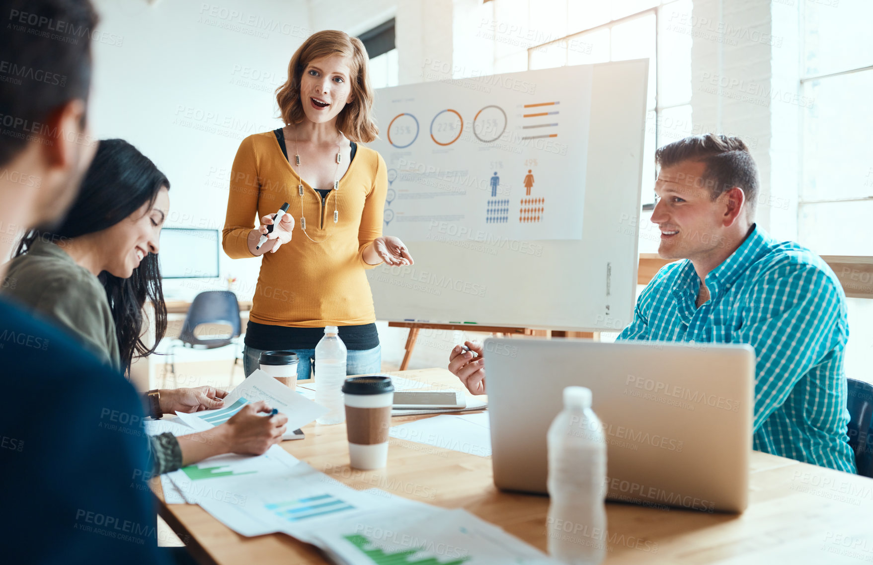 Buy stock photo Shot of a group of young businesspeople having a meeting in a modern office