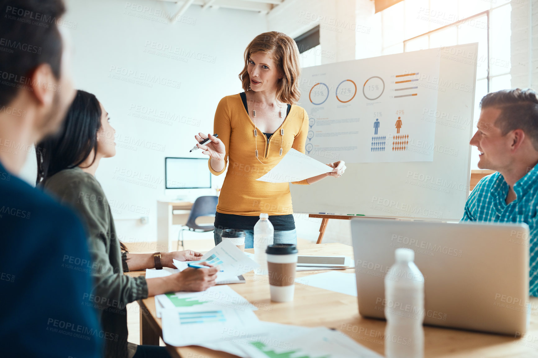 Buy stock photo Shot of a group of young businesspeople having a meeting in a modern office