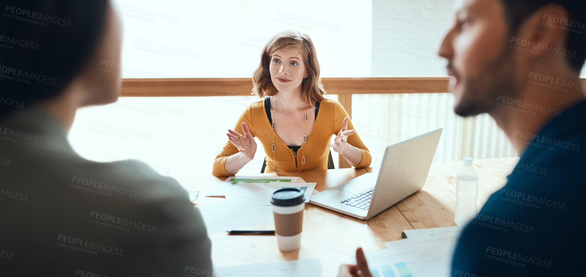 Buy stock photo Shot of a group of young businesspeople having a meeting in a modern office