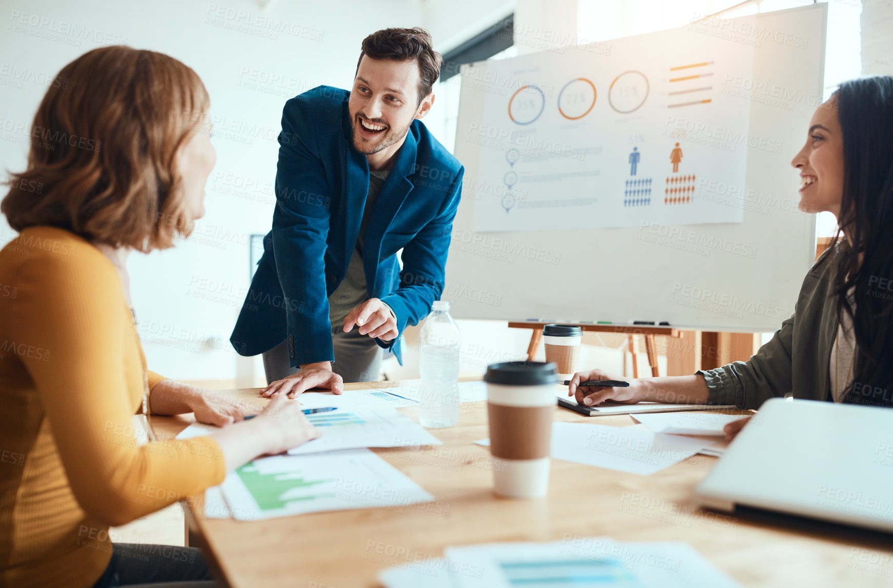 Buy stock photo Shot of a group of young businesspeople having a meeting in a modern office