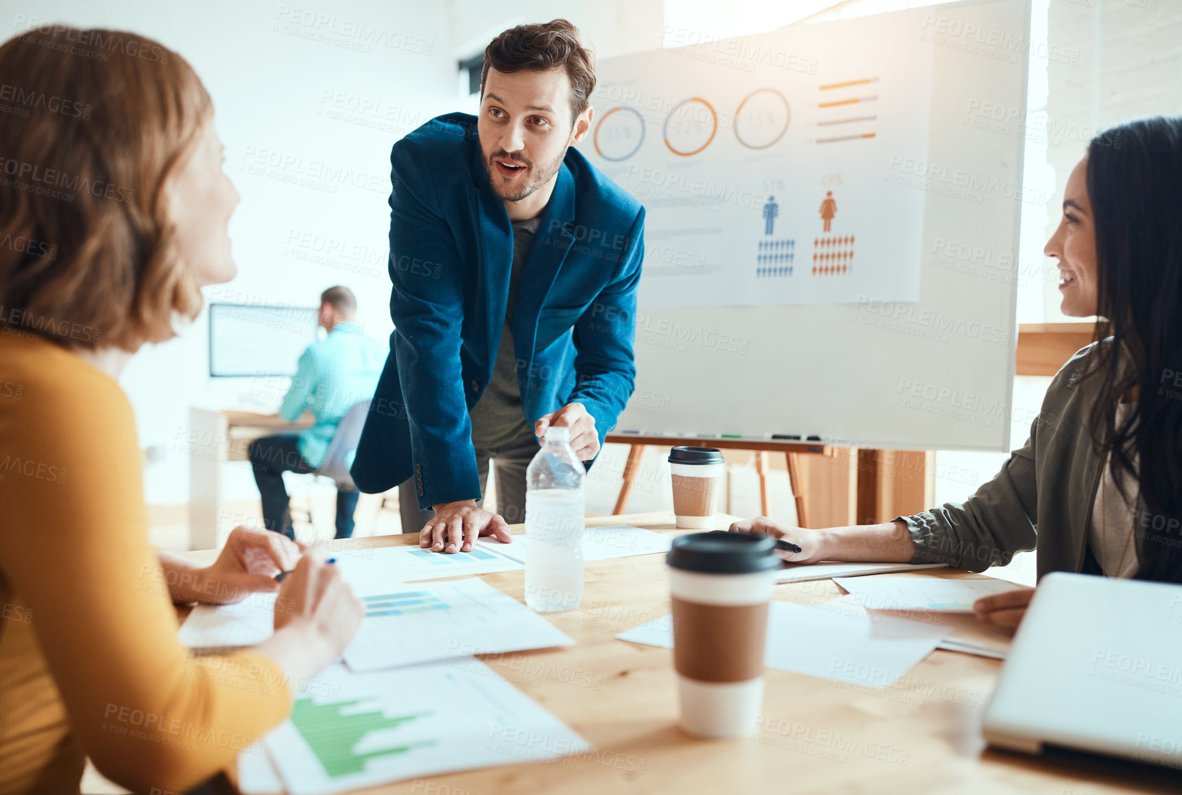 Buy stock photo Shot of a group of young businesspeople having a meeting in a modern office