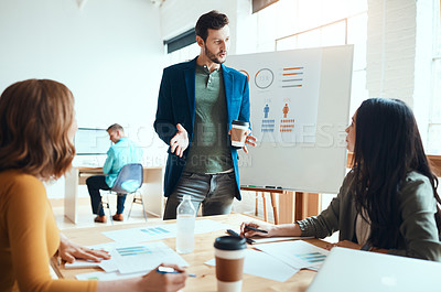 Buy stock photo Shot of a group of young businesspeople having a meeting in a modern office