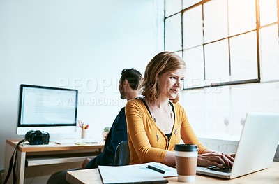 Buy stock photo Cropped shot of an attractive young businesswoman working on her laptop in a modern office