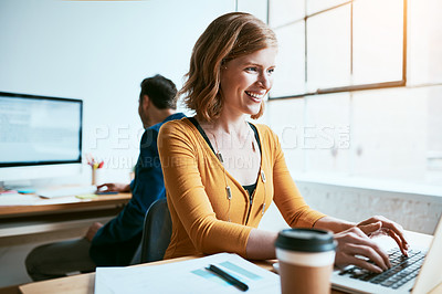 Buy stock photo Cropped shot of an attractive young businesswoman working on her laptop in a modern office