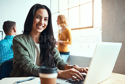 Buy stock photo Cropped portrait of an attractive young businesswoman working in a modern office with her colleagues in the background