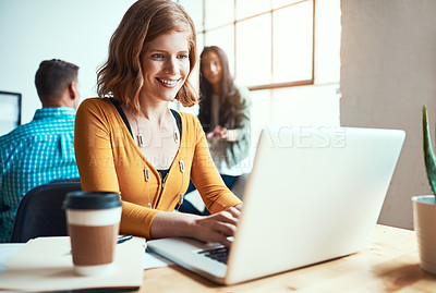 Buy stock photo Cropped shot of an attractive young businesswoman working in a modern office with her colleagues in the background