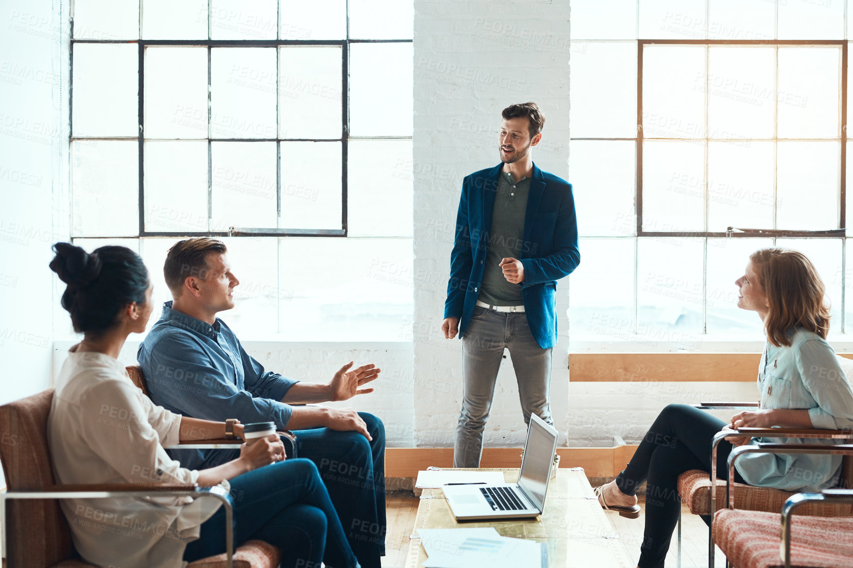 Buy stock photo Shot of a group of young businesspeople having a meeting in a modern office