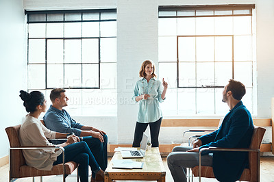 Buy stock photo Shot of a group of young businesspeople having a meeting in a modern office