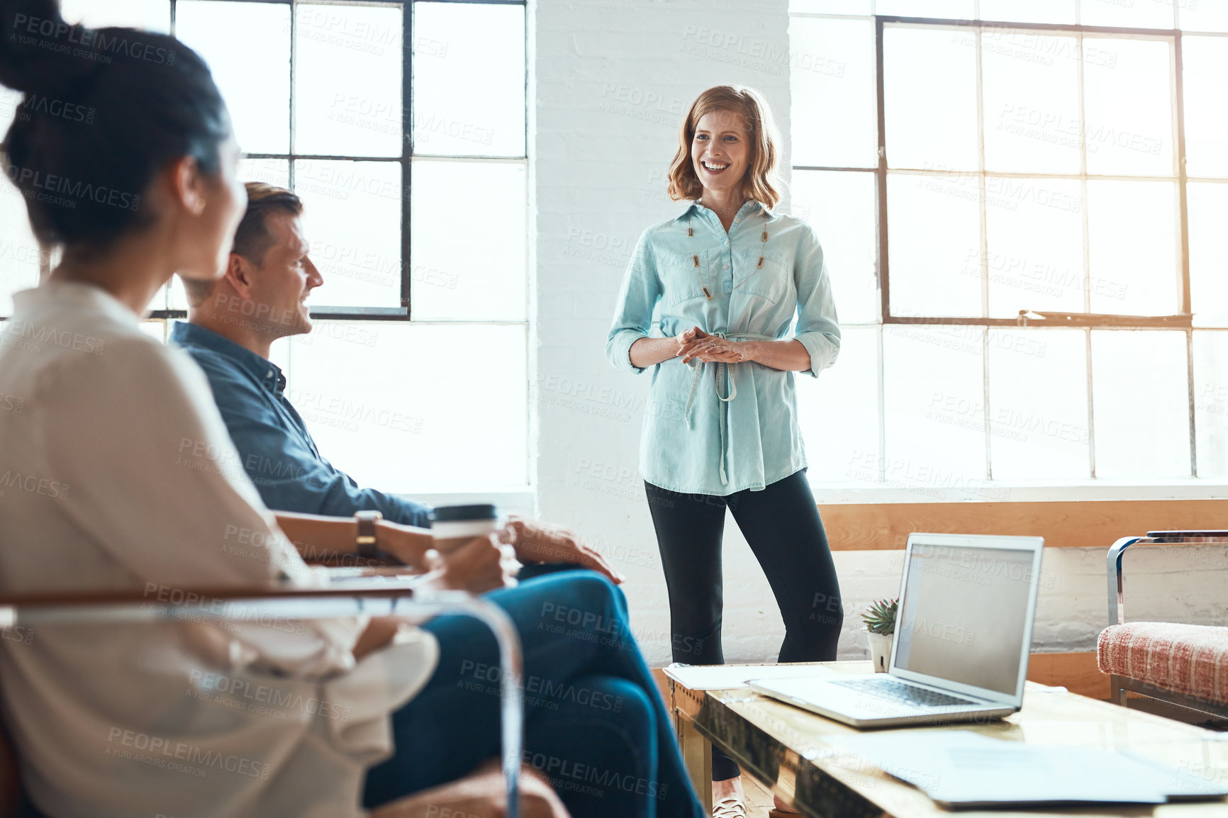 Buy stock photo Shot of a group of young businesspeople having a meeting in a modern office