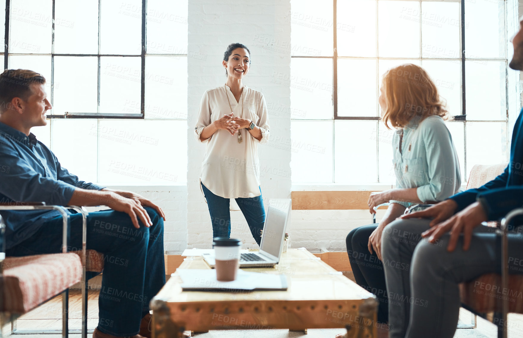 Buy stock photo Shot of a group of young businesspeople having a meeting in a modern office