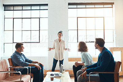 Buy stock photo Shot of a group of young businesspeople having a meeting in a modern office