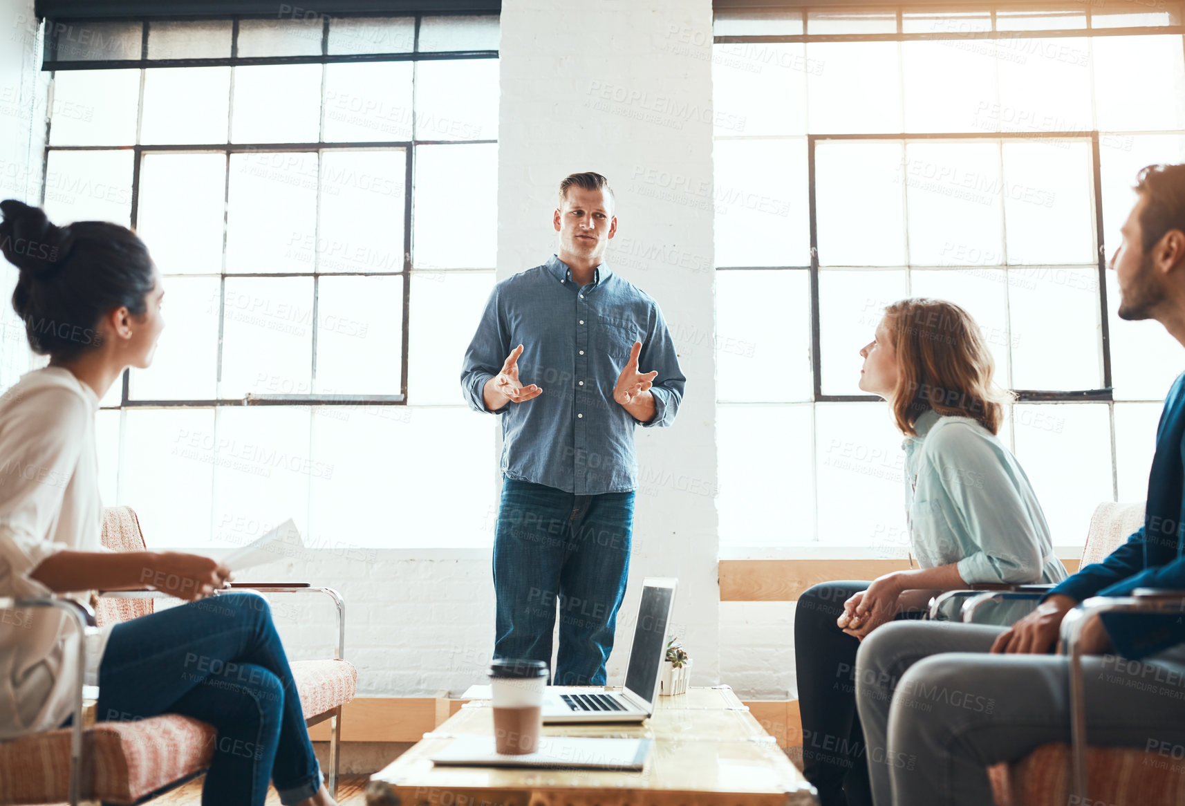 Buy stock photo Shot of a group of young businesspeople having a meeting in a modern office