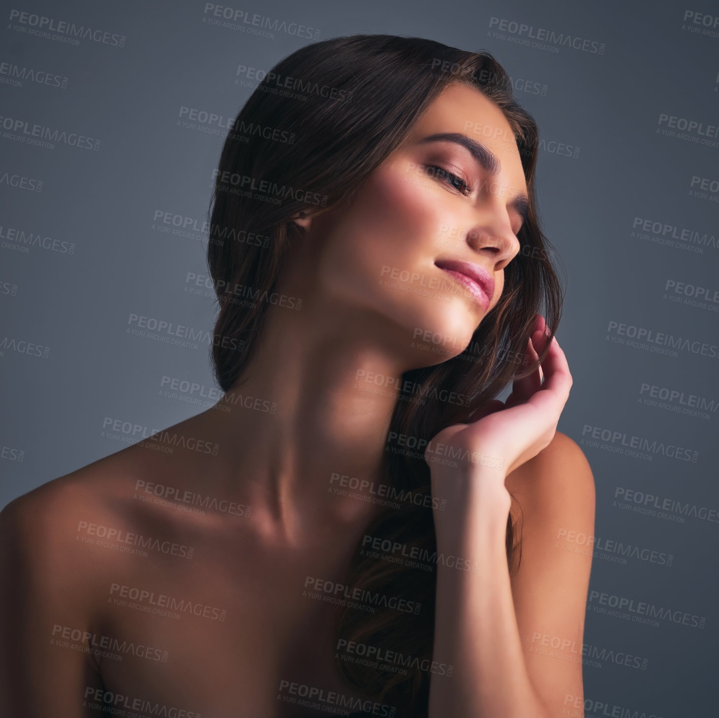 Buy stock photo Studio shot of an attractive young woman posing against a grey background